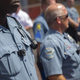 Members of the Ferguson Police Department wear body cameras during a rally Aug. 30, 2014, in Ferguson, Mo. Michael Brown, an unarmed 18-year-old, was shot and killed Aug. 9, 2014, by then-Ferguson Police Officer Darren Wilson.
Aaron P. Bernstein/Getty Images